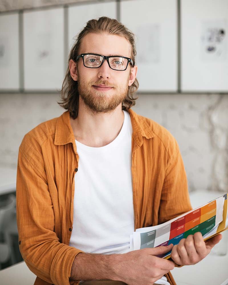 smiling-boy-with-blond-hair-and-beard-in-glasses-l-Y6DZ9EA.jpg